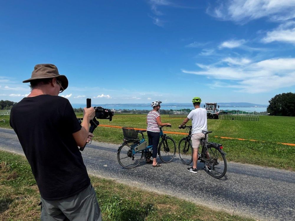 Zwei Velofahrer beobachten den Lohnunternehmer Ralf Hug beim Gülle ausbringen. Bild: kim